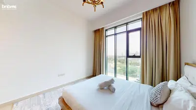 a bedroom with a bed with a teddy bear on it at bnbmehomes - Vida Residence A1 in Dubai