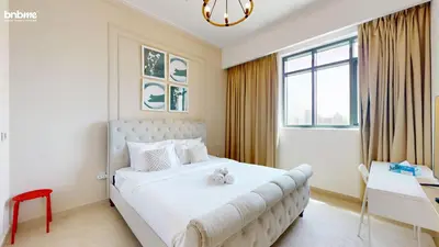a bedroom with a large white bed and a window at bnbmehomes - Vida Residence A1 in Dubai