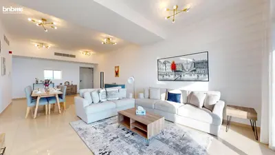 a living room with a white couch and a table at bnbmehomes - DEC Tower 1 in Dubai