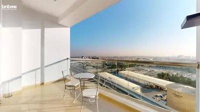 a balcony with tables and chairs and a train on it at bnbmehomes - DEC Tower 1 in Dubai