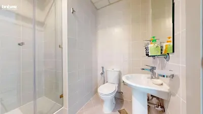 a bathroom with a toilet and a sink and a shower at bnbmehomes - DEC Tower 1 in Dubai