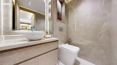 a bathroom with a sink and a toilet and a mirror at bnbmehomes - The Lofts Central in Dubai