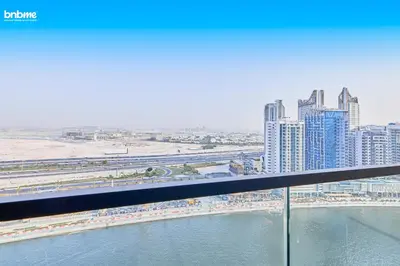 a view of a city from a bridge over the water at bnbmehomes - Trillionaire Residences By Binghatti in Dubai