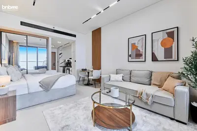 a bedroom with a bed and a living room at bnbmehomes - Trillionaire Residences By Binghatti in Dubai