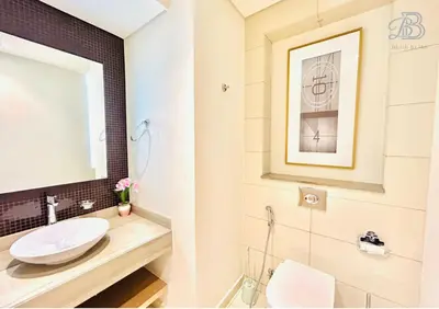a bathroom with a sink and a mirror at 1 Bedroom Apartment in Paramount Tower - A in Dubai