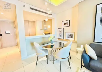 a dining room with a table and chairs at 1 Bedroom Apartment in Paramount Tower - A in Dubai