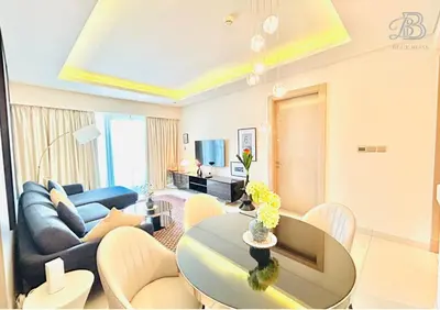 a living room with a couch and a table at 1 Bedroom Apartment in Paramount Tower - A in Dubai