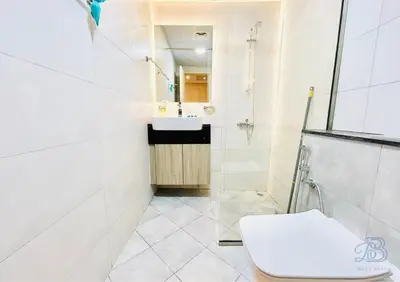 a white bathroom with a sink and a toilet at 1 Bedroom Apartment in Al Jaddaf - High-Floor with Dubai Skyline View in Dubai