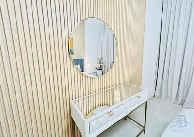 a bathroom with a mirror on a striped wall at 1 Bedroom Apartment in Al Jaddaf - High-Floor with Dubai Skyline View in Dubai