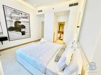 a white bedroom with a bed in a room at Stylish 2 Bedroom Apartment in the Heart of JVC - with swimming pool, fully equipped gym, outdoor steam room, kids play area & lots more in Dubai