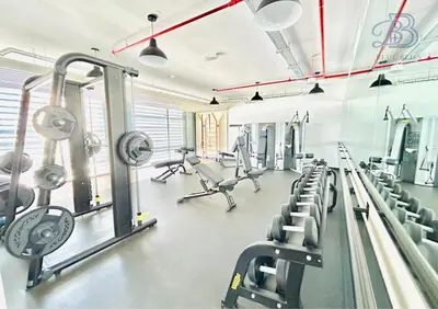 a gym with treadmills and machines in a room at Stylish 2 Bedroom Apartment in the Heart of JVC - with swimming pool, fully equipped gym, outdoor steam room, kids play area & lots more in Dubai