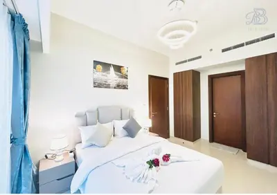 a bedroom with a white bed with flowers on it at 2 Bedroom Apartment with Canal View in Business Bay in Dubai