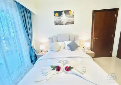 a bedroom with a bed with two flowers on it at 2 Bedroom Apartment with Canal View in Business Bay in Dubai