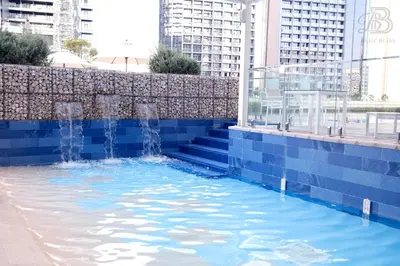 a swimming pool with water in the middle of a city at 2 Bedroom Apartment with Canal View in Business Bay in Dubai