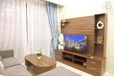 a living room with a large entertainment center with a television at 2 Bedroom Apartment with Canal View in Business Bay in Dubai