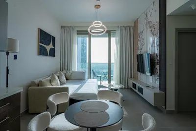 a living room with a couch and a table at Elegant Downtown Escape 1BR w Balcony, Pool & Gym in Dubai