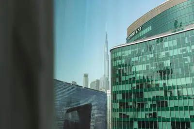 a view of a tall glass building in a city at Urban Studio - Business Bay in Dubai