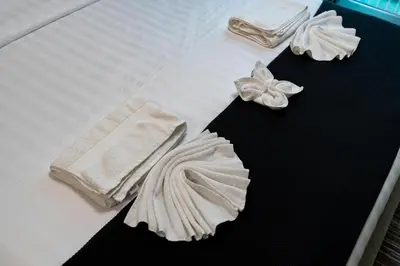a bed with white towels on top of it at Urban Studio - Business Bay in Dubai