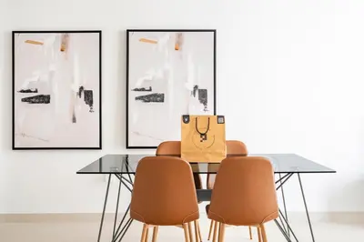 a dining room with a table and four chairs at The Grand Luxury Residential I1Bedroom I High Floor I Water View I Tennis & Badminton Courts I Rooftop Lounge in Dubai