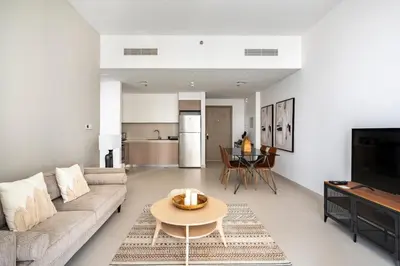a living room with a couch and a table at The Grand Luxury Residential I1Bedroom I High Floor I Water View I Tennis & Badminton Courts I Rooftop Lounge in Dubai
