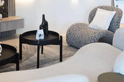a living room with a chair and a table at 2 Bedroom Apartment in Business Bay Gym, Pool & View in Dubai