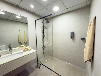 a bathroom with a shower and a sink at Luxury Studio Apartment with large Balcony and Sea Views, free Parking, Dubai Marina - JBR in Dubai