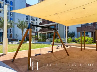 a swing set in front of a building at LUX The Dubai Creek Beach Suite 2 in Dubai
