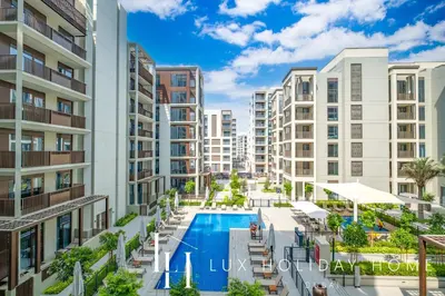 an image of an apartment complex with a swimming pool at LUX The Dubai Creek Beach Suite 2 in Dubai