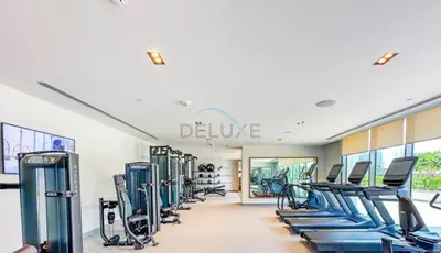 a gym with a row of cardio machines at Boulevard Views, Steps from Burj Khalifa & Dubai Mall, Near Metro Station and Few Mins Drive to Dubai Marina - Burj Crown, Downtown Dubai by Deluxe Holiday Homes in Dubai