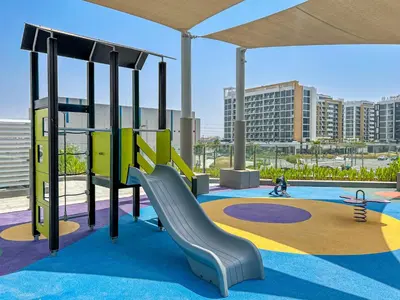 a playground with a slide in a building at 1BR Azizi Riviera 44 City Skyline View in Dubai