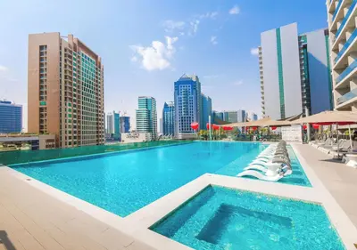 a large swimming pool on the roof of a building at Stylish Stay, Walk to Dubai Mall, Downtown in Dubai