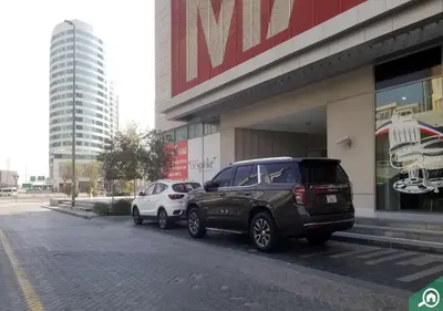 two cars parked in front of a building at Stylish Stay, Walk to Dubai Mall, Downtown in Dubai