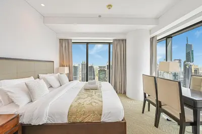 a bedroom with a bed and a desk with a window at One Bed Marina View on 34th floor in Dubai