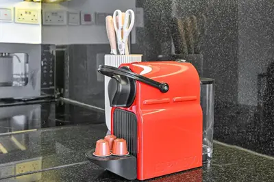 a red appliance sitting on top of a kitchen counter at One Bed Marina View on 34th floor in Dubai