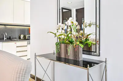 a kitchen with a vase of flowers on a counter at One Bed Marina View on 34th floor in Dubai