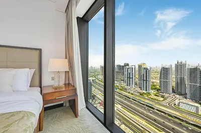 a bedroom with a bed and a large window at One Bed Marina View on 34th floor in Dubai