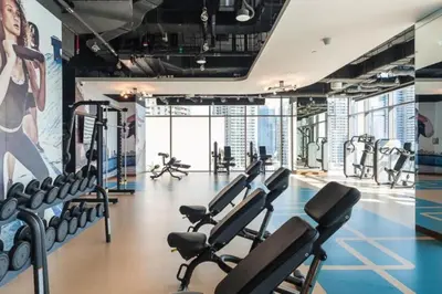 a gym with a bunch of cardio equipment in it at Marina Gate 2 - High Rise One Bed with Marina View in Dubai