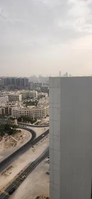 a view of a city with a building and a highway at Opalz by danube in Dubai