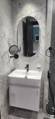a bathroom with a white sink and a mirror at Opalz by danube in Dubai