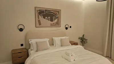 a bedroom with a bed with two towels on it at Urban Sunset, Newly Renovated Central 1BR in Dubai