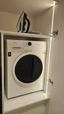 a microwave oven with a clock on top of it at Urban Sunset, Newly Renovated Central 1BR in Dubai