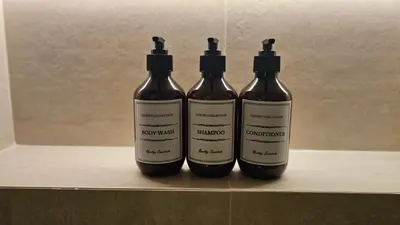 three bottles of wine sitting on a shelf at Urban Sunset, Newly Renovated Central 1BR in Dubai