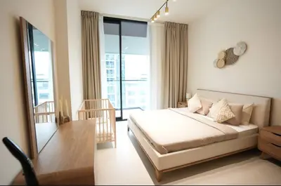 a bedroom with a bed and a large window at 2BR Luxury Baby, Gym & Pool in Dubai