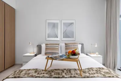 a bedroom with a bed with a table with fruit on it at Maison Privee - Sky-High Panoramic Apt with Iconic Burj Khalifa Vws in Dubai