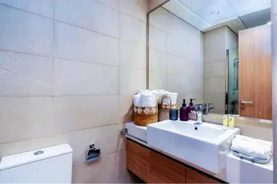a bathroom with a sink and a mirror at Guest Favorite - Relaxed and Cozy Studio Near Racecourse in Dubai