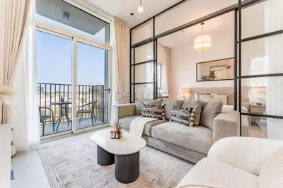 a living room with a couch and a table at Walk to Dubai Hills Mall, Premium Amenities And Near Dubai Hills Park And Golf Club, Socio Tower 1, Dubai Hills by Deluxe Holiday Homes in Dubai