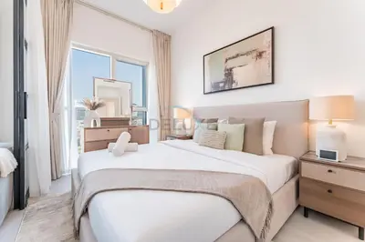 a white bedroom with a large bed and a window at Walk to Dubai Hills Mall, Premium Amenities And Near Dubai Hills Park And Golf Club, Socio Tower 1, Dubai Hills by Deluxe Holiday Homes in Dubai