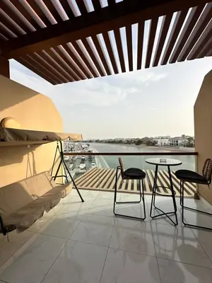 a balcony with two chairs and a table and a view at Luxury studio with full sea view in Dubai