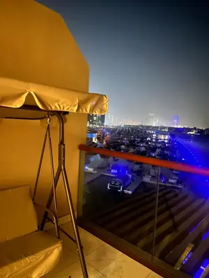 a room with a balcony with a view of a parking lot at Luxury studio with full sea view in Dubai