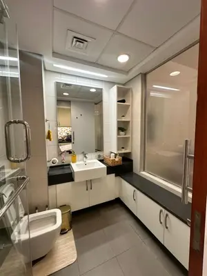 a bathroom with a sink and a large mirror at Luxury studio with full sea view in Dubai